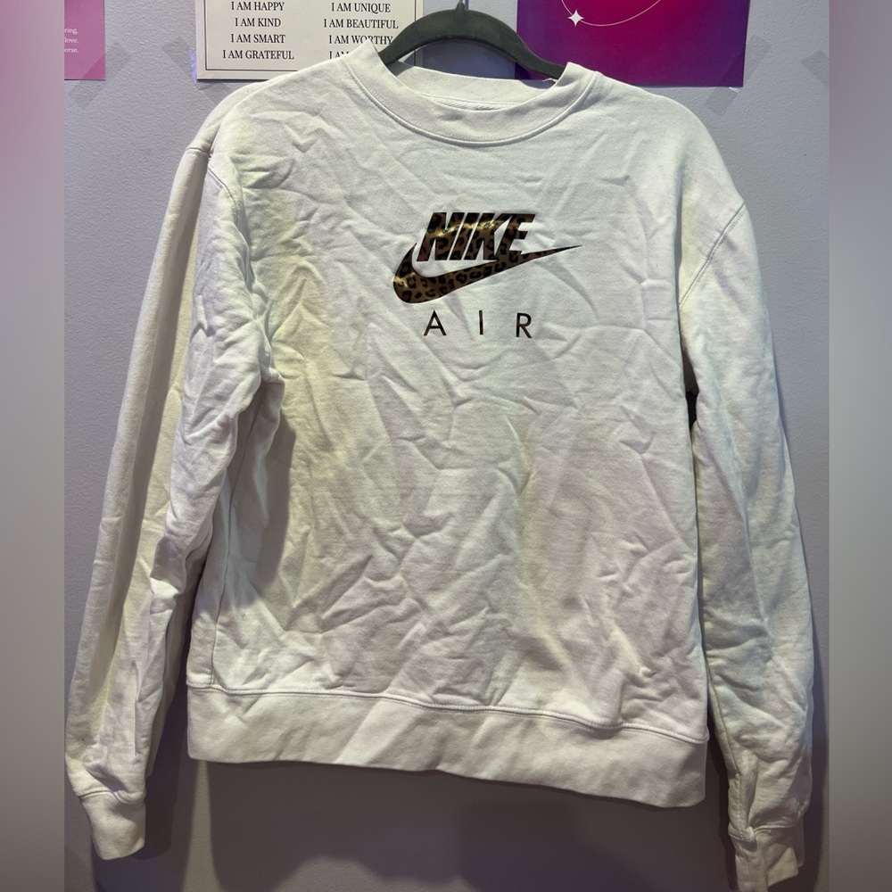 White cheetah print Nike crewneck sweatshirt.